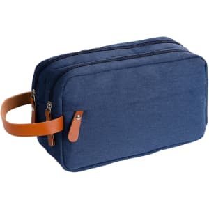 A navy toiletry bag with a brown leather handle and two zippered compartments. Features a branding logo.