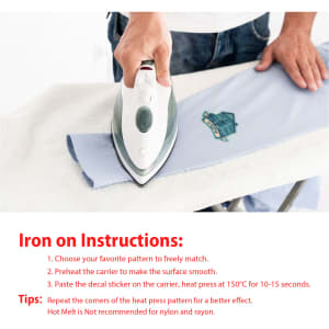 An iron is being used to apply a custom woven patch on light blue fabric. The patch features a logo.