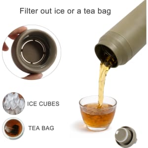 A drink bottle in a muted olive green colour with a filter lid, pouring liquid into a glass.