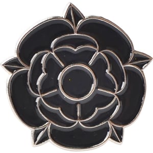 A black rose-shaped lapel pin with a silver outline and detailing, featuring an embedded logo.