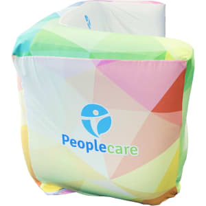 An inflatable two-seat sofa in a vibrant, multi-coloured design with a logo.