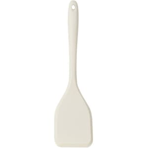 A silicone spatula in a cream colour with a long handle and a flat head, featuring a hanging hole.