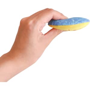 A hand holds a blue and yellow water bouncing disc with a textured surface. The disc has a logo on it.