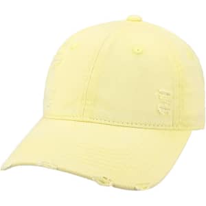 A vintage baseball cap in a light yellow colour with distressed detailing and a rounded crown.
