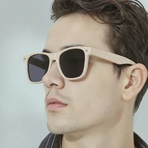 Wheat straw sunglasses in a light colour with dark lenses, showcased on a model's face.