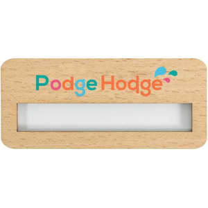 A wooden name badge in natural colour with a transparent window and a logo featuring vibrant colours.
