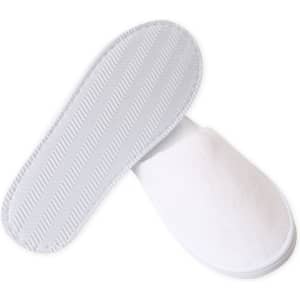 White hotel slippers with a soft fabric exterior and textured rubber soles, featuring a simple design and a logo.