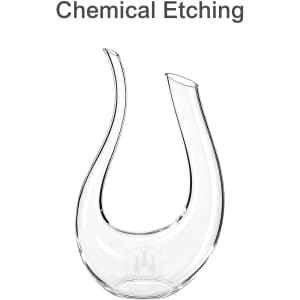A U-shaped clear glass wine decanter with an elegant, curved design and two spouts. It features a logo.