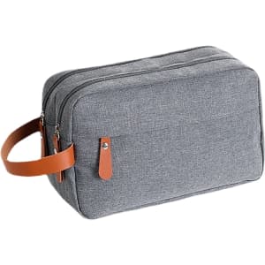 A grey toiletry bag with a leather handle and zippers. It features a simple, stylish design.