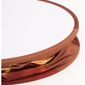 A round, backlit LED display with a smooth, white surface and an orange fabric border, featuring a hidden storage area.