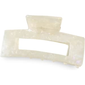 A large, iridescent hair claw clip in an elegant rectangular shape, featuring a logo on the side.