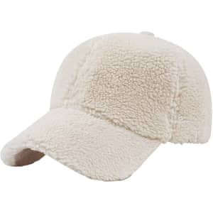 A cream lamb fur baseball cap with a curved visor and a soft, textured surface. It features a logo on the side.