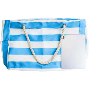 A blue and white striped beach bag with rope handles and a silver tablet placed beside it. It features a logo.