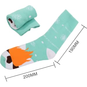 A pair of mint green socks with a playful pattern featuring a soccer ball and flame design, rolled up beside it.