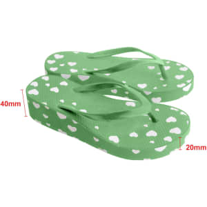 Green flip-flops with white heart patterns, featuring a textured surface and a slight rise in height.