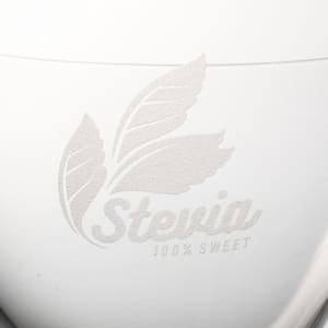 A white container with a logo featuring leaves and the word "Stevia" embossed on it.