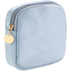 A stylish mini makeup bag in soft blue fabric with a zip closure and gold-tone zipper pull. Features a simple design.