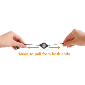 A pair of black retractable earbuds held by hands, showcasing the pull mechanism with a central control unit.