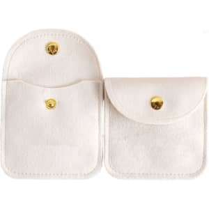 A square velvet jewellery pouch in light cream with a gold button closure and two compartments.