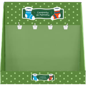 A green corrugated cardboard counter display with polka dots and hooks for hanging items. It features a festive design.
