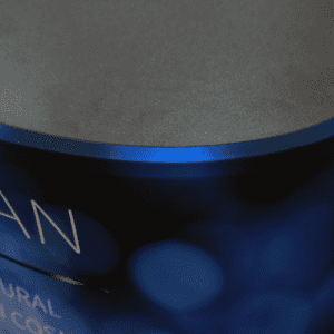 A blue oval popup booth with a smooth, dark top surface, featuring an abstract design.