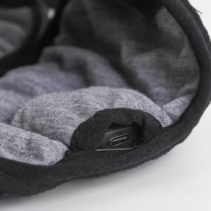 A pair of Bluetooth sleep headphones in black and grey, featuring a USB-C charging port.