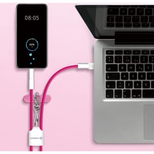 A pink 4-in-1 charging phone lanyard connected to a laptop and a smartphone displaying battery percentage.