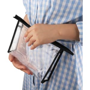 A clear PVC cosmetic bag with black zippers is held in hands, showcasing its transparent design.