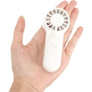A portable handheld fan in white, fitting comfortably in a person's hand, featuring a circular grille and a button.