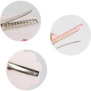 A pink custom shape acrylic hair clip with a metallic clasp, featuring a scalloped design and a logo.