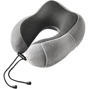 A grey memory foam U-shaped travel pillow with a textured inner lining and a drawstring closure.