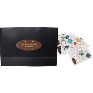 A black small paper bag with flat handles alongside various decorative stickers.