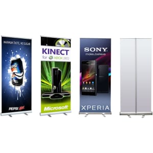 Four pull-up banners in various designs. Colours include black, green, blue, and white. Each banner features a logo or branding.