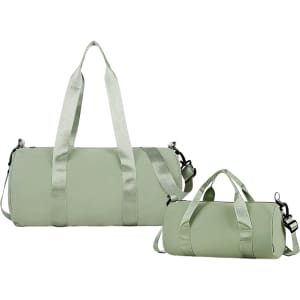 A light green bucket duffle bag with wide straps, featuring both a large and a smaller bag with handles.