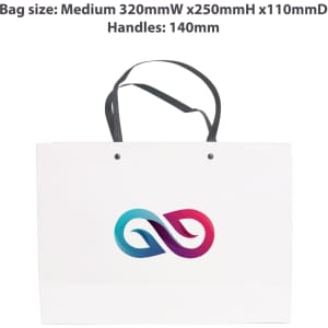 A medium white paper bag with a knitted black handle and a colourful logo on the front.