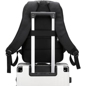 A black expandable laptop backpack resting on a wheeled suitcase, showcasing padded straps and back panel.