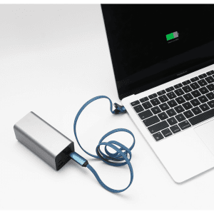 A silver charging device connected to a laptop with a blue 3-in-1 charging cable.