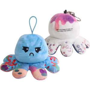 A small reversible octopus plush toy featuring blue on one side, with an angry face, and white on the other with a playful design.