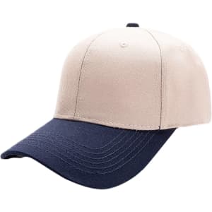 A beige and navy blue 6 panel adjustable baseball cap with a logo on the front.