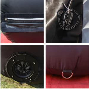 Details of a large inflatable arch showing black fabric, zippers, attachment points, and a fan vent.