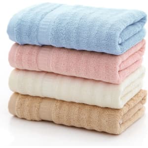 A stack of bamboo fiber towels in blue, pink, cream, and beige, neatly folded with a textured design.