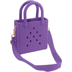 A mini beach bag in purple with holes and dual handles, featuring a detachable shoulder strap.