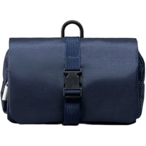 A navy folding travel toiletry bag featuring a buckle strap and a mesh pocket. It has a simple, compact design.