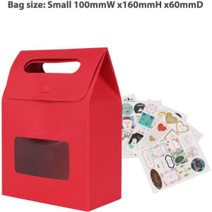 A red die cut handle bag with a clear window, accompanied by various decorative stickers.