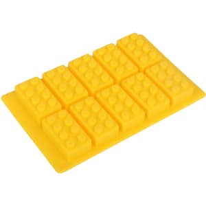 A yellow silicone ice cube tray shaped like building blocks, featuring eight moulded sections with rounded bumps.