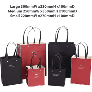 A collection of knitted handle bags in red and black, featuring varying sizes and designs, with handles and a logo.
