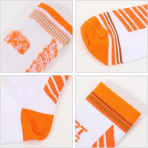 Crew woven sport socks in white and orange, featuring various patterns and stripes, with a logo present on the design.