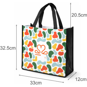 A vibrant tote bag featuring a multi-coloured abstract pattern, black handles, and a logo on one side.