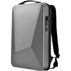 A silver expandable hardshell backpack with a geometric design and adjustable straps. It features a handle and a locking mechanism.