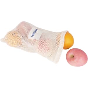A cream-coloured organic cotton mesh bag containing oranges and a pink apple, with a logo visible.
